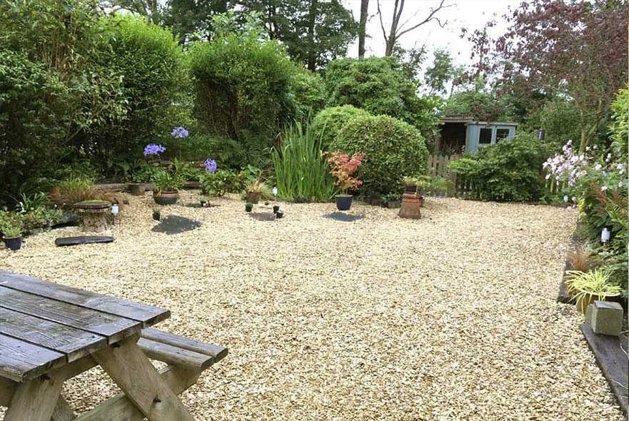 Cottage Garden: Top Entertaining Area The top gravelled entertaining area of the cottage garden with a small wildlife pond and picket fence.