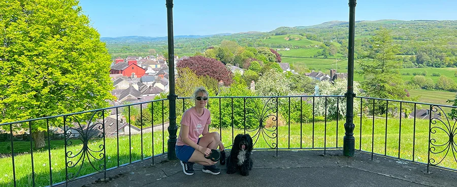 Melanie and Lily in Llandeilo Melanie and her dog Lily standing near the bandstand in Llandeilo, Wales.