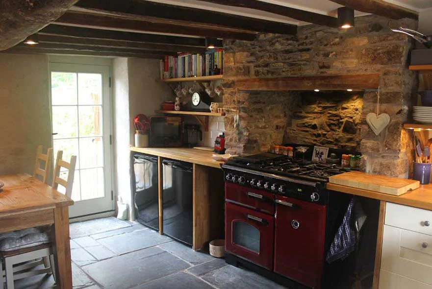 Cottage Kitchen Renovation The renovated cottage kitchen, featuring the unblocked original fireplace and reclaimed slate floor.